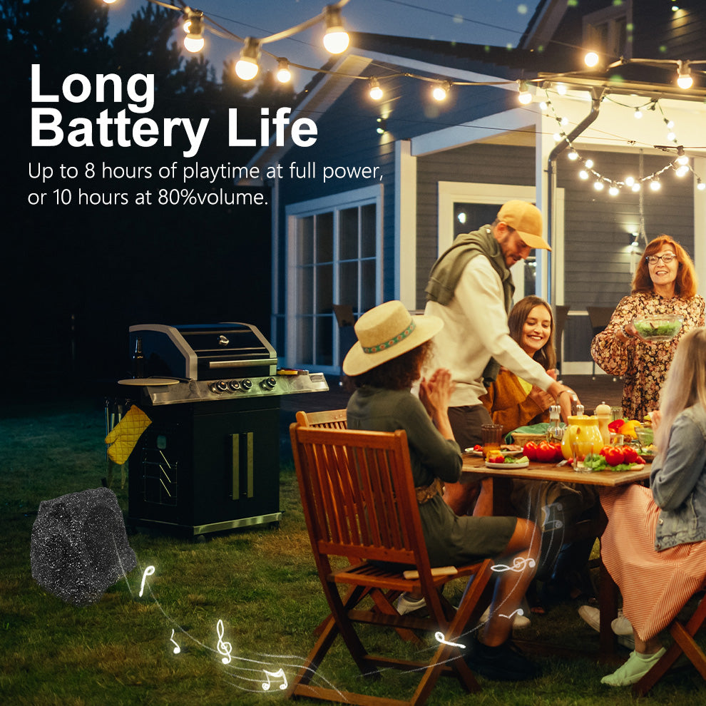 Herdio solar rock speaker playing at an outdoor patio gathering at night