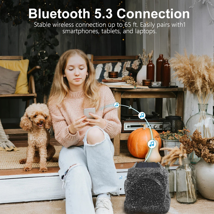 Herdio Bluetooth 5.3 rock speaker paired with a smartphone on a patio